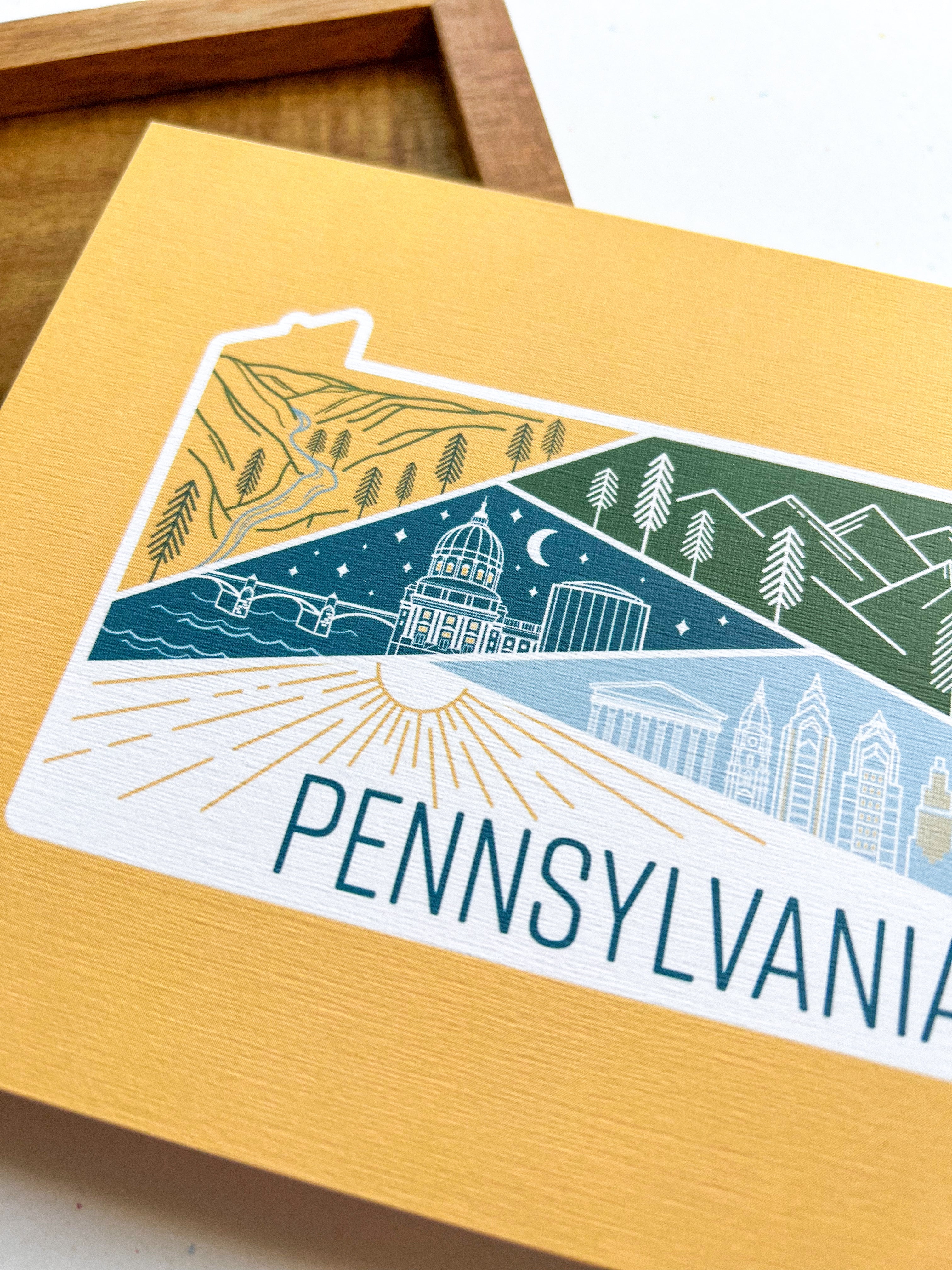 A postcard with an illustrated map of Pennsylvania, featuring a variety of colors and depicting landmarks and scenery.