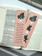 front and back rectangular bookmarks with rounded corners, featuring a green plant illustration and a Colossians 3:23-24 Bible verse, placed on a patterned fabric surface.