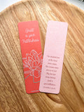Two bookmarks with double-sided illustrations, one in red and one in pink, with text and a floral design on each.
