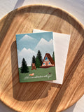 "Life is an adventure with you" greeting card with outdoor cabin mountain illustration cad with envelope and wooden background