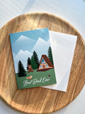 "Best Dad Ever" greeting card with outdoor cabin mountain illustration cad with envelope and wooden background