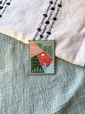 Geometric design of Arizona stamp shaped magnet on a fabric background