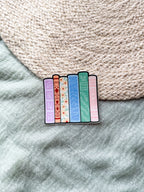 Colorful book spins sticker on a textured fabric background