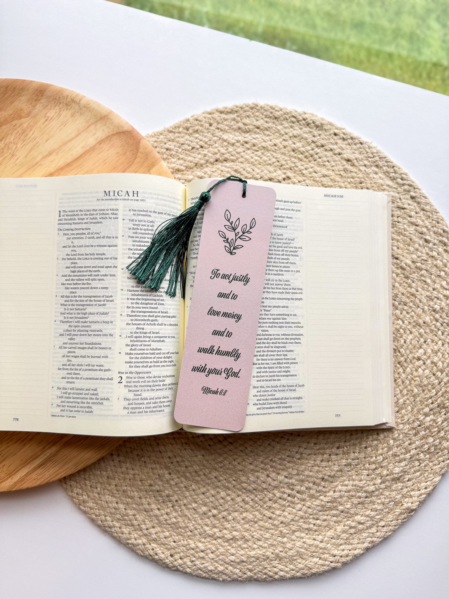  bookmark with one having a green floral pattern and the other a beige grennery design, both with text on them, placed in a clear poly sleeve.