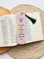 bookmarks with one having a green floral pattern and the other a beige grennery design, both with text on them, placed in a clear poly sleeve.