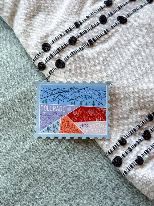 Colorful Colorado-themed stamp shaped ticker on a textured fabric background