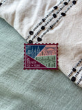 New York themed decorative sticker  stamp shaped on a textured fabric background