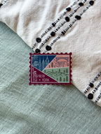 New York themed decorative sticker  stamp shaped on a textured fabric background