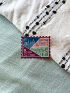 New York themed decorative sticker  stamp shaped on a textured fabric background