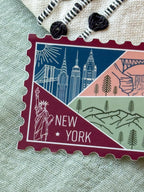 New York themed decorative sticker  stamp shaped on a textured fabric background