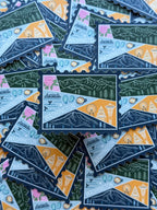 Colorful Washington-themed stamp sticker on a textured fabric surface 