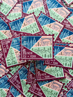 New York themed decorative sticker  stamp shaped on a textured fabric background