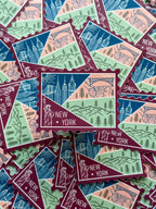 New York themed decorative sticker  stamp shaped on a textured fabric background