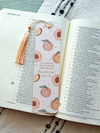 Open bible with a peach pattern bookmark on a textured fabric surface