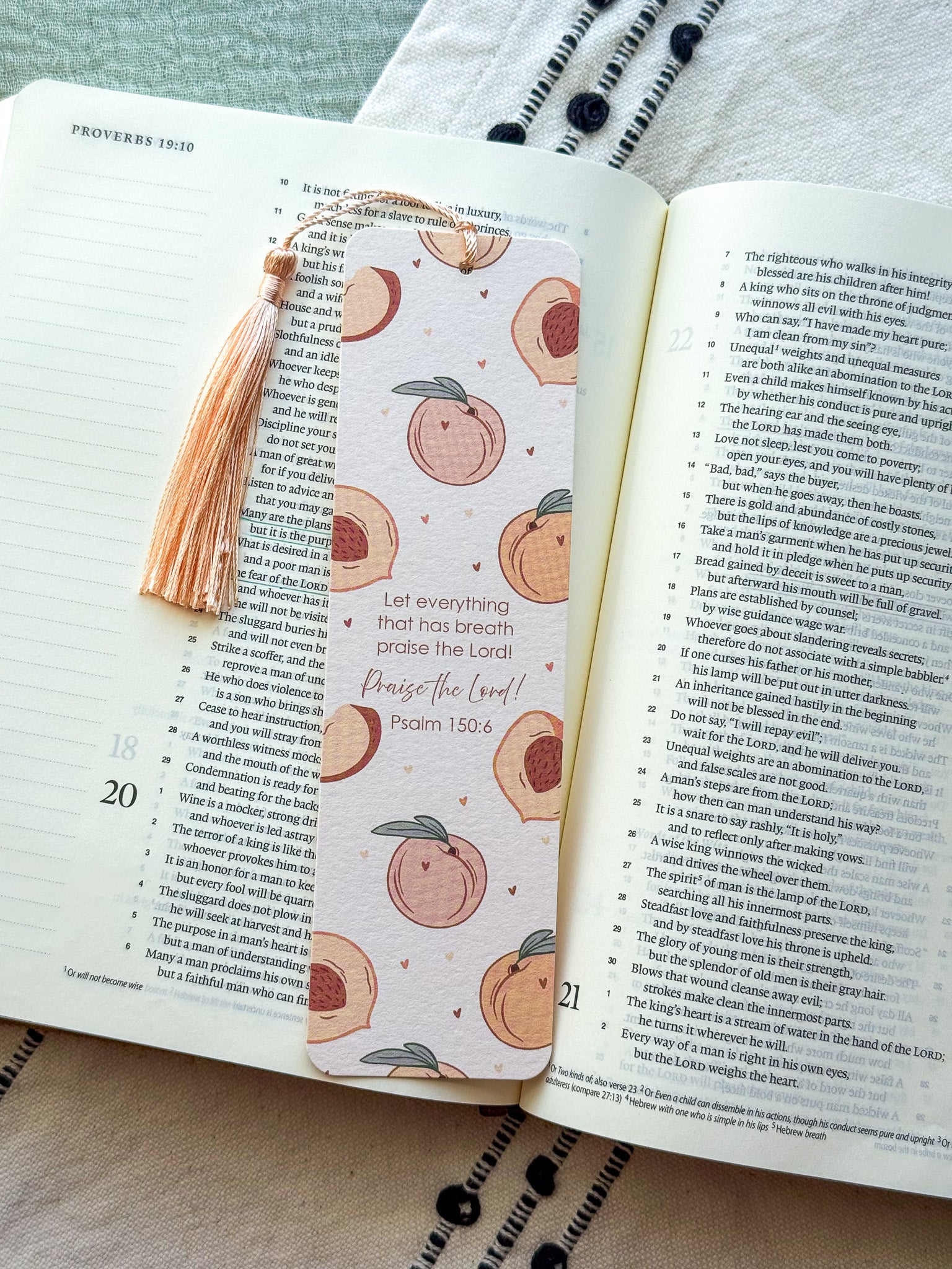 Open bible with a peach pattern bookmark on a textured fabric surface