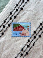 Sticker of Connecticut stamp design on a textured surface with decorative elements