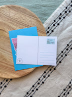 Colorful Minnesota-themed back of postcard on a textured surface