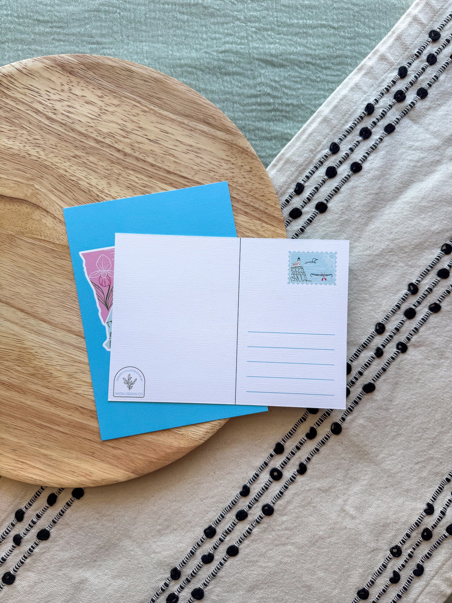Colorful Minnesota-themed back of postcard on a textured surface