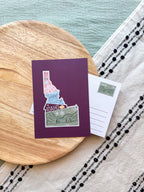 Colorful Idaho themed postcard on a textured surface