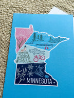 Minnesota-themed card with illustrations on a blue background
