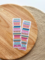 colorful pile of books illustrated bookmarks with quotes on the spin on a wooden background