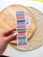 colorful pile of books illustrated bookmarks with quotes on the spin on a wooden background
