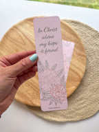 pink peony bookmark featuring floral designs and text "in Christ alone my hope is found" on a woven surface.
