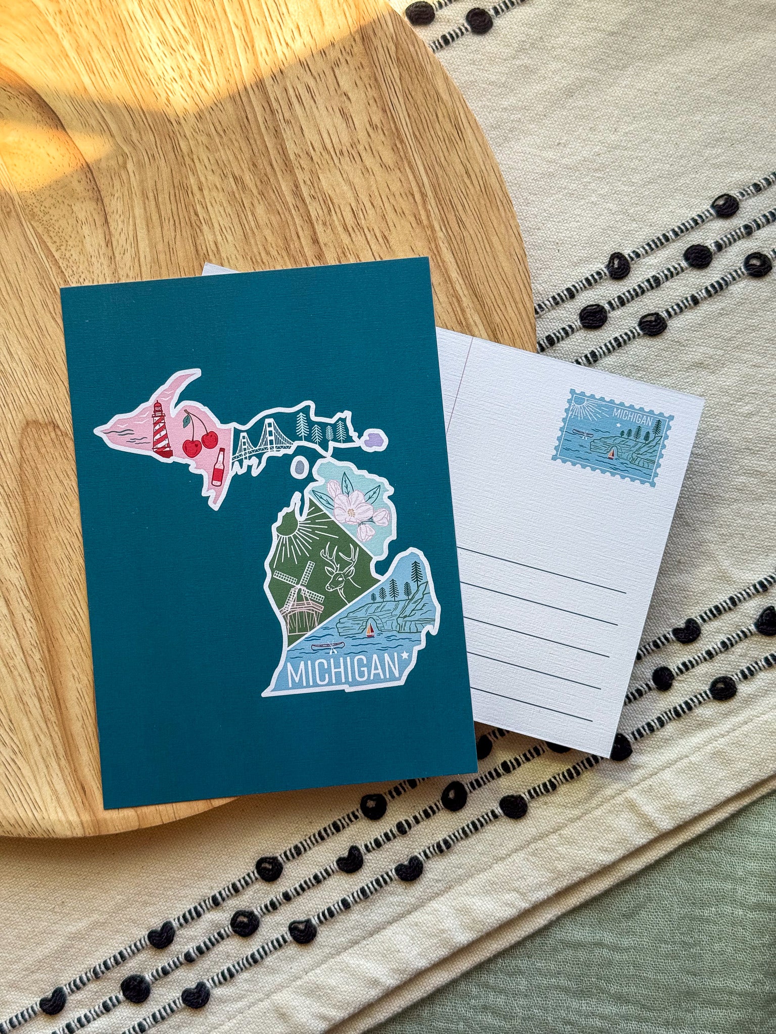 postcard with Michigan design on a wooden surface