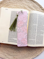 pink peony bookmark featuring floral designs on a woven surface.