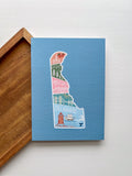 A postcard with an illustration of Delaware state in a colorful artistic style on a blue background.