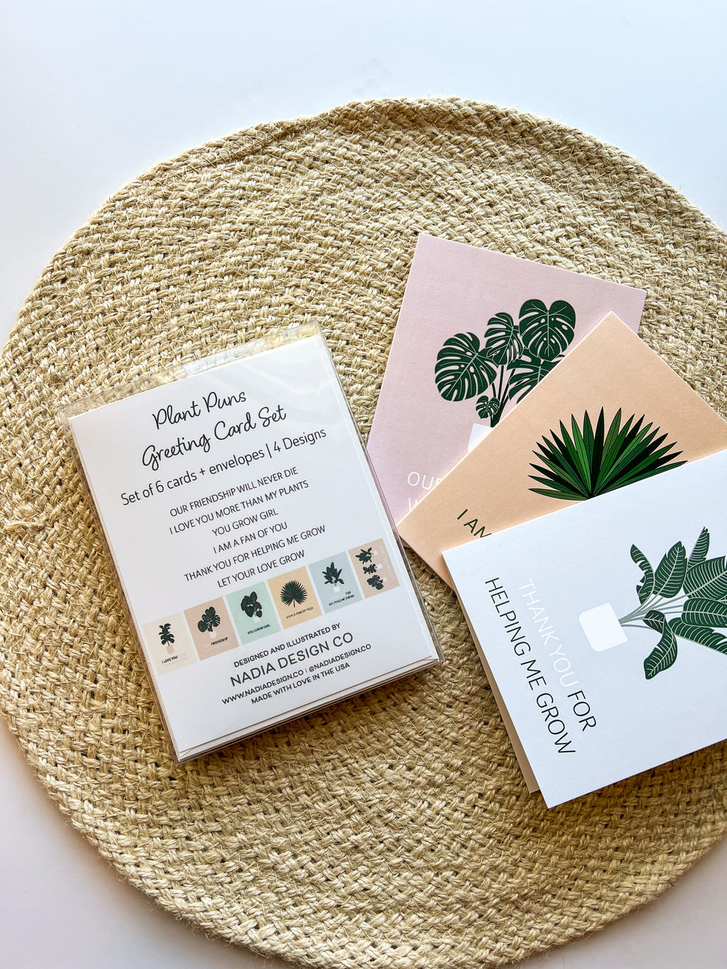 A set of six illustrated greeting cards with various houseplants and punny captions related to plants displayed on a wooden surface.