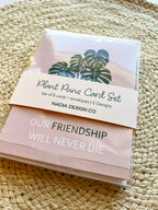 A set of six illustrated greeting cards with various houseplants and punny captions related to plants displayed on a wooden surface.