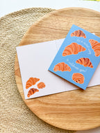 it's a sweet way to celebrate you Greeting card with croissant illustrations on a wooden surface