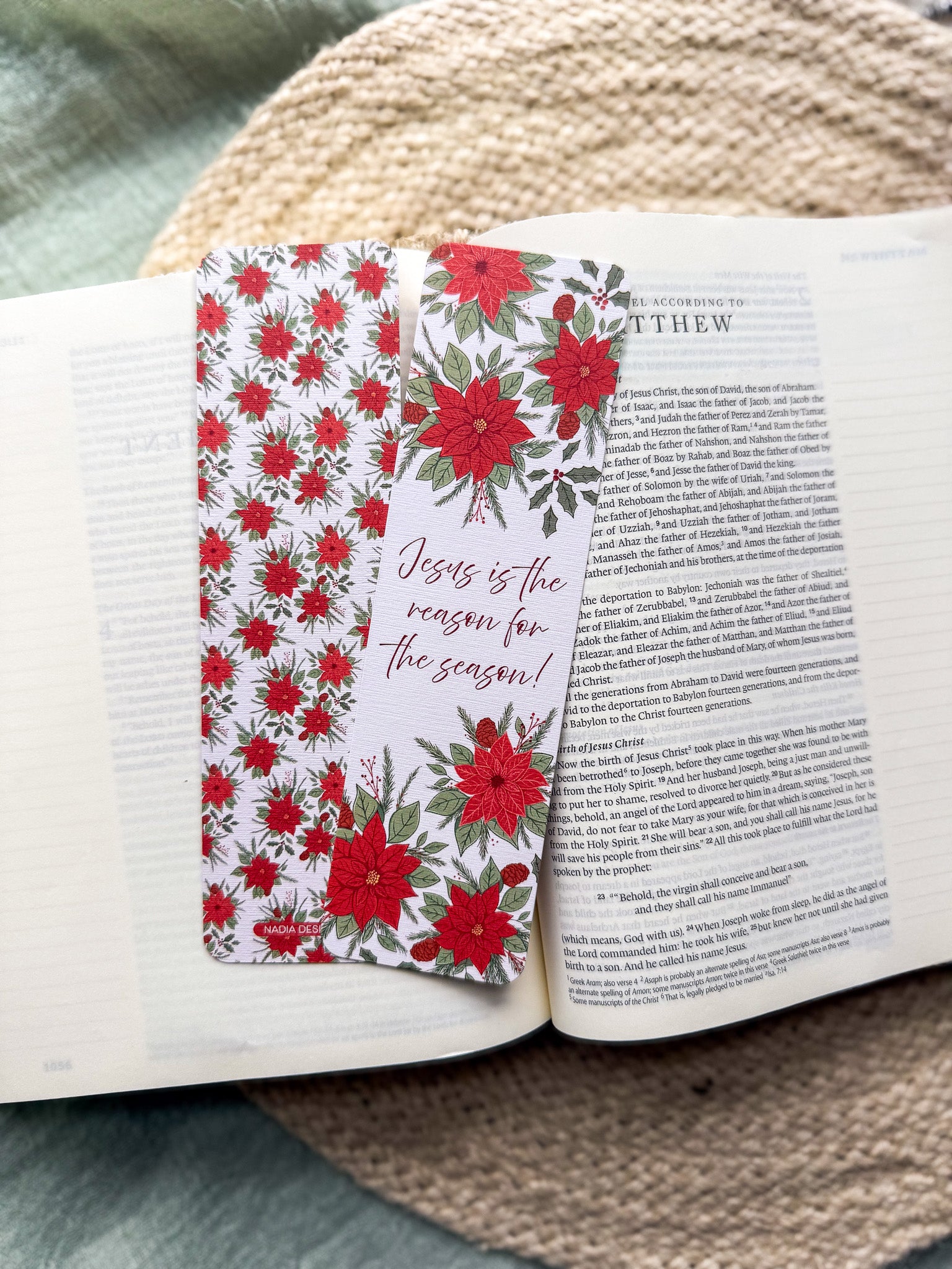 poinsettia Floral Christian bookmark with text" Jesus is the reason for the season"  on a textured surface