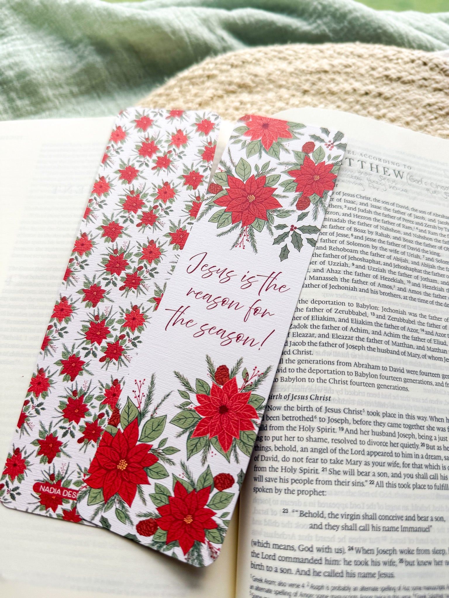 poinsettia Floral Christian bookmark with text" Jesus is the reason for the season" on a textured surface