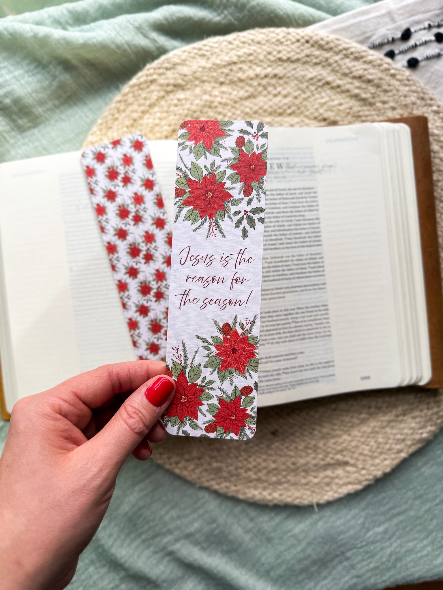 poinsettia Floral Christian bookmark with text" Jesus is the reason for the season"  on a textured surface