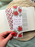 poinsettia Floral Christian bookmark with text" Jesus is the reason for the season" on a textured surface