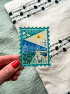 illustrated New Jersey Acrylic Stamp Magnet held and textured fabric behind