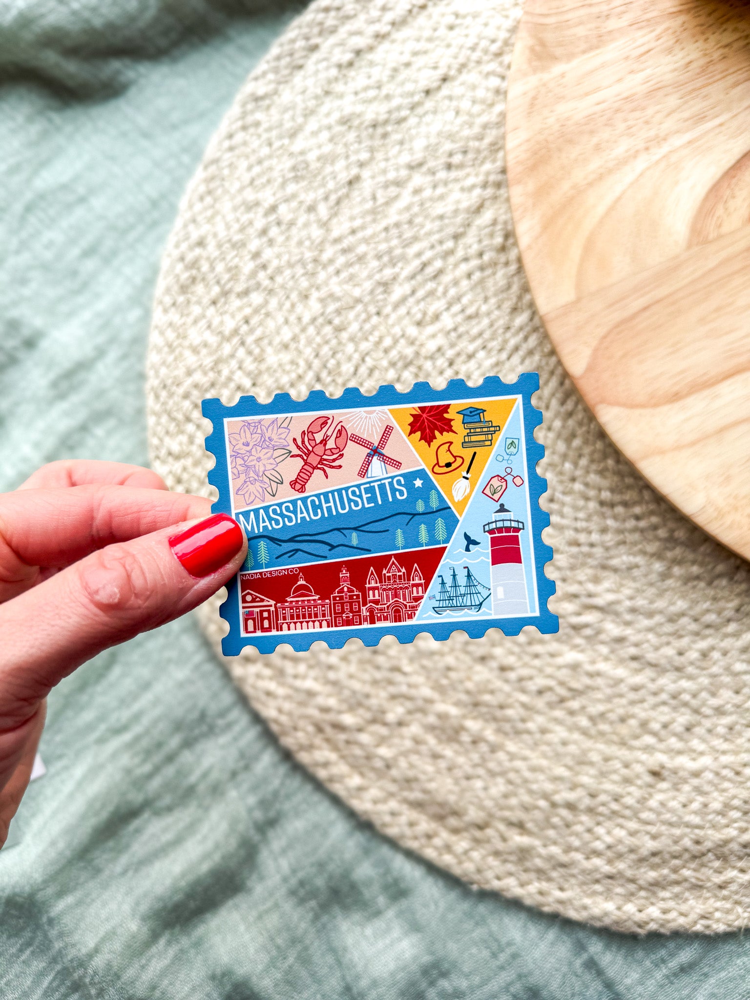 Colorful Massachusetts stamp shaped magnet on a textured surface