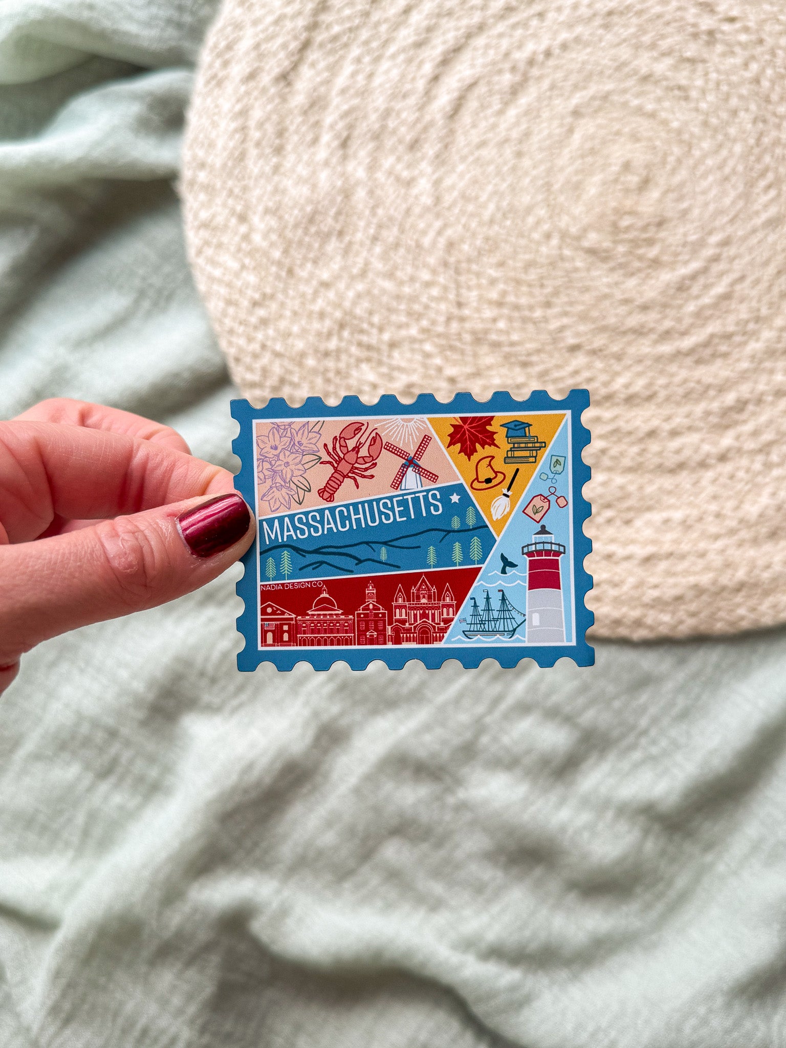 Colorful Massachusetts stamp-shaped magnet on a textured surface