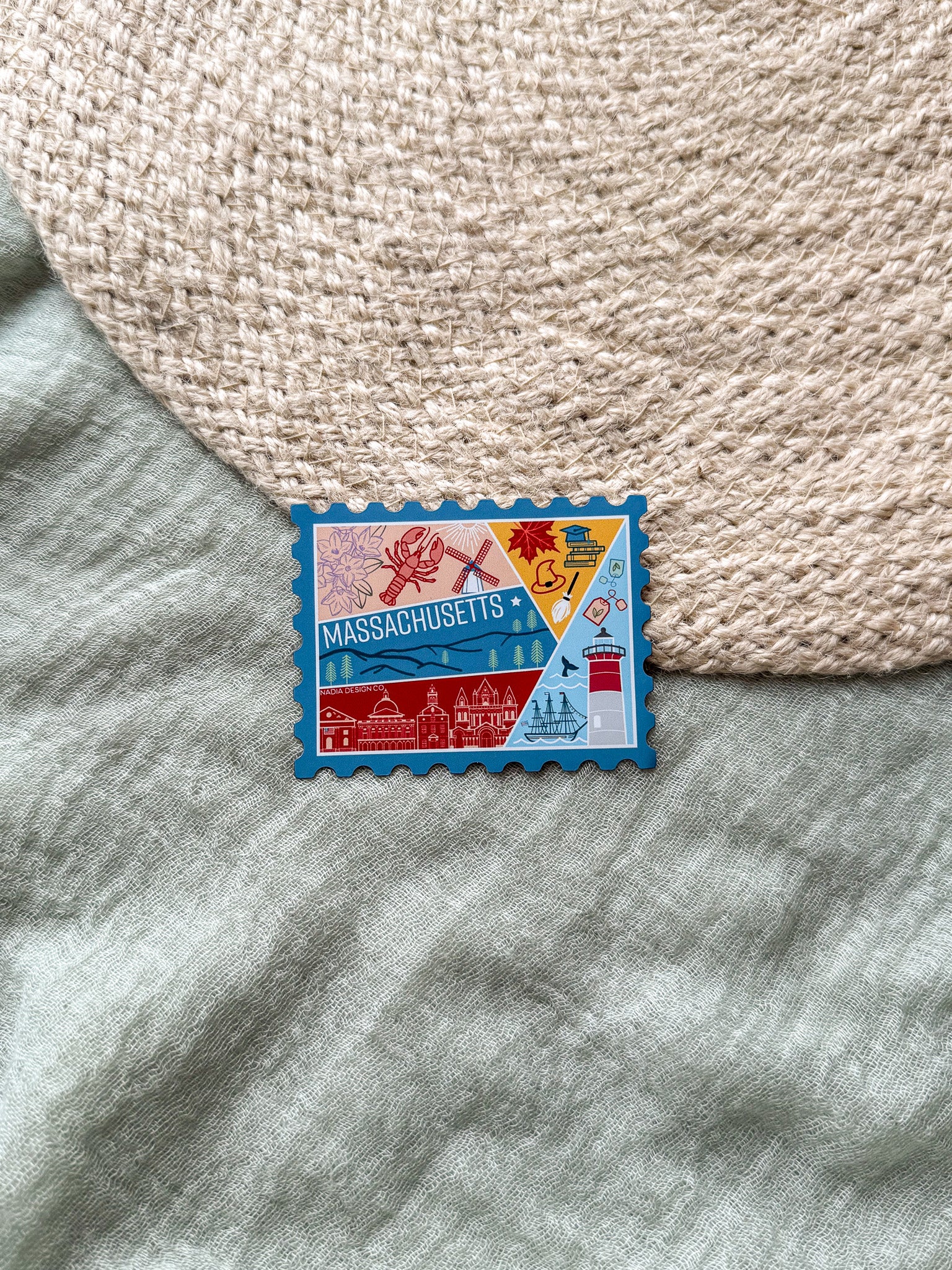 Colorful Massachusetts stamp shaped magnet on a textured surface