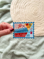 Colorful Massachusetts stamp shaped magnet on a textured surface