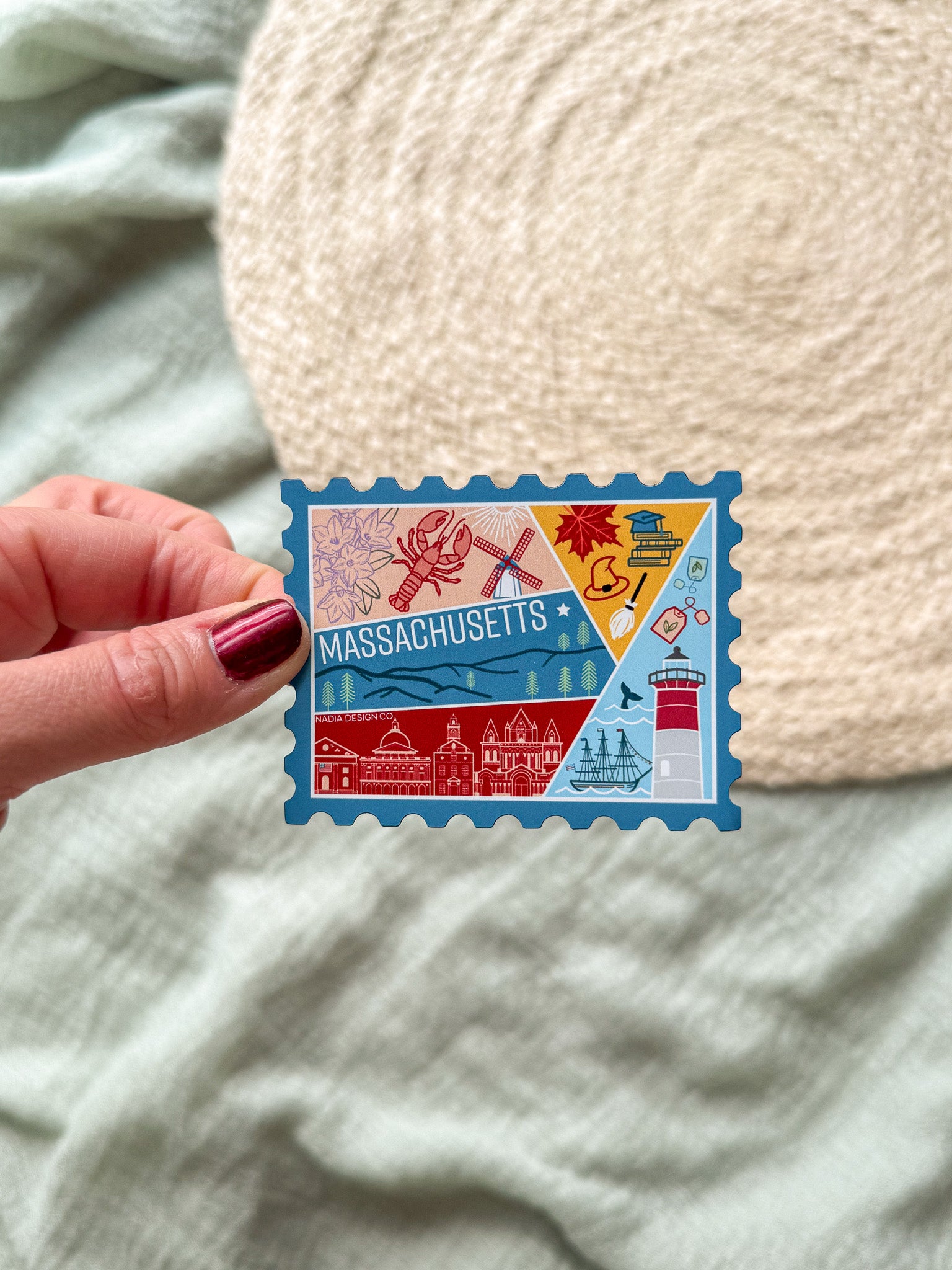 Colorful Massachusetts stamp shaped magnet on a textured surface