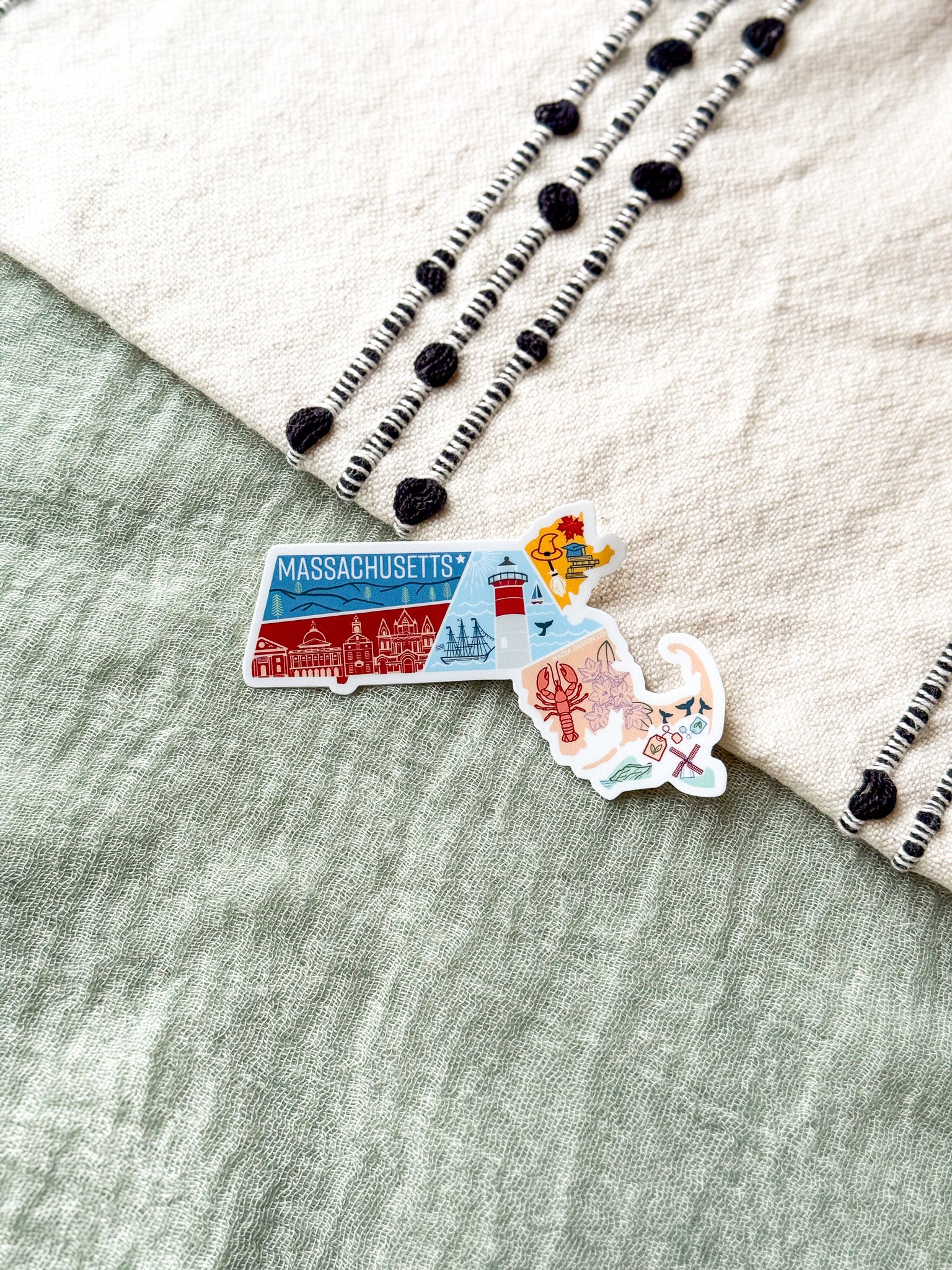Colorful Massachusetts-shaped sticker on a textured surface