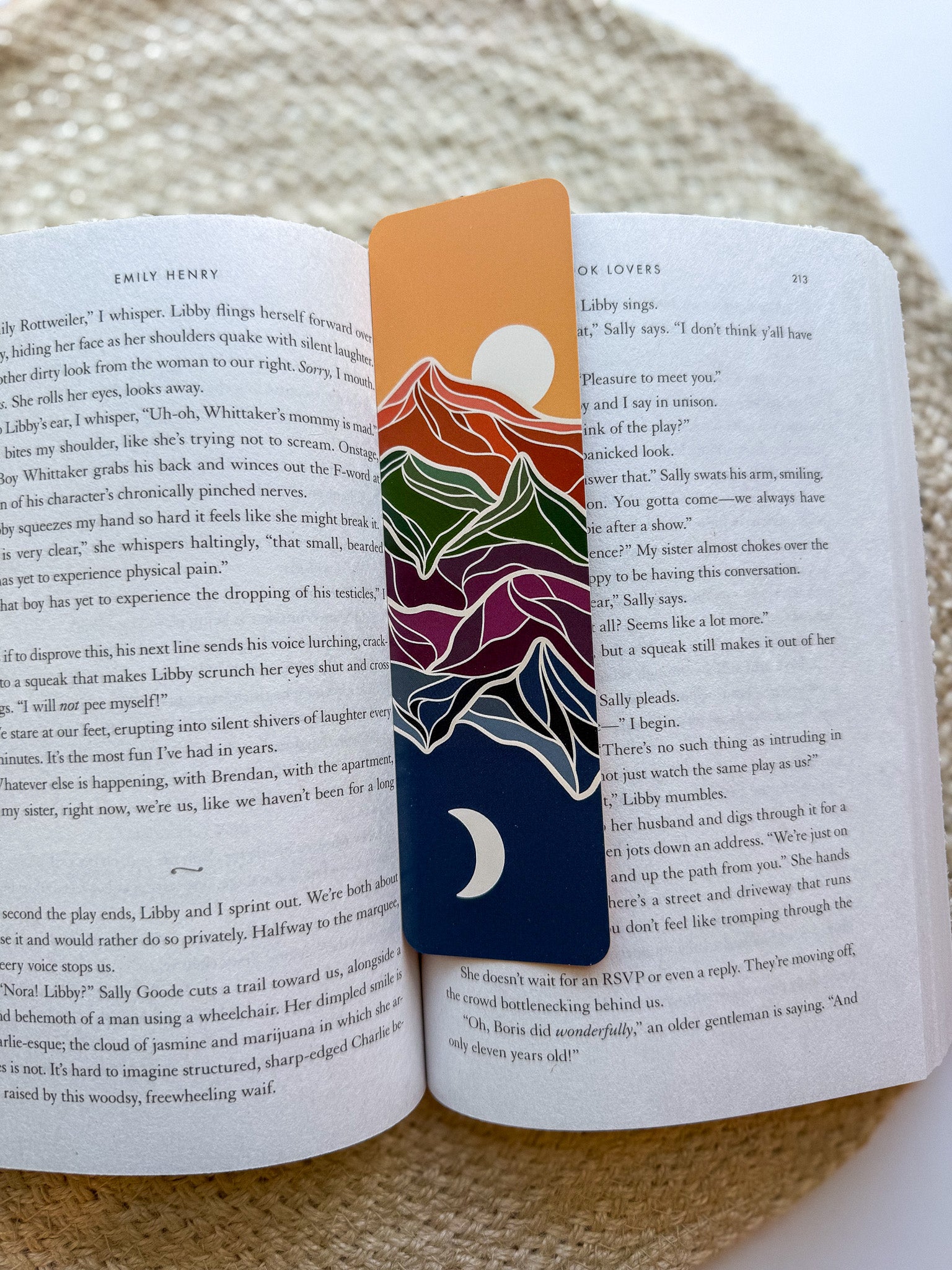 Colorful mountain-themed bookmark on an open book