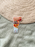 Sticker of Vermont on a textured surface