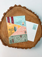A colorful postcard featuring an illustration of California's landscape, including mountains, a beach, and iconic symbols like palm trees and a sailboat.
