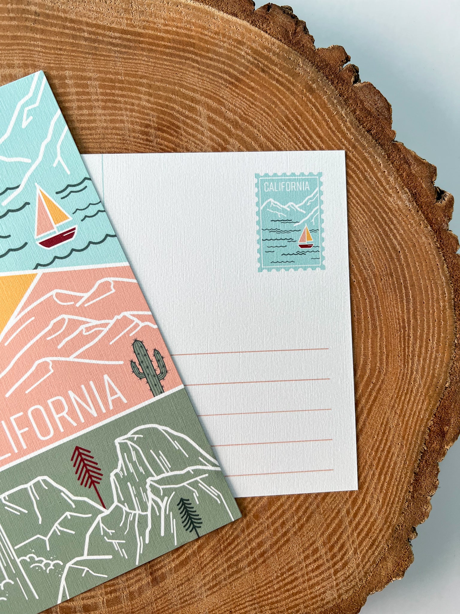 A colorful postcard featuring an illustration of California's landscape, including mountains, a beach, and iconic symbols like palm trees and a sailboat.