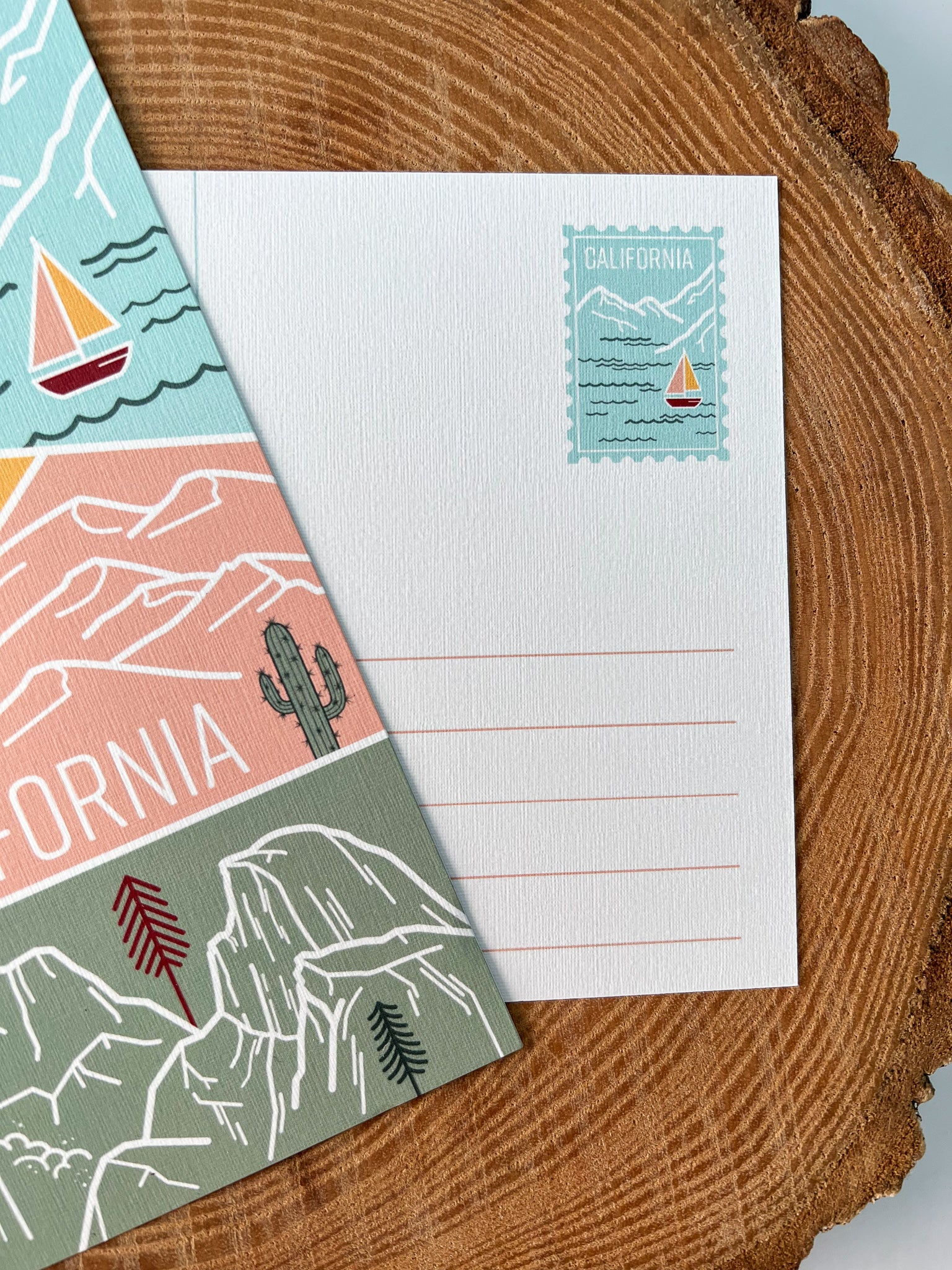 A colorful postcard featuring an illustration of California's landscape, including mountains, a beach, and iconic symbols like palm trees and a sailboat.