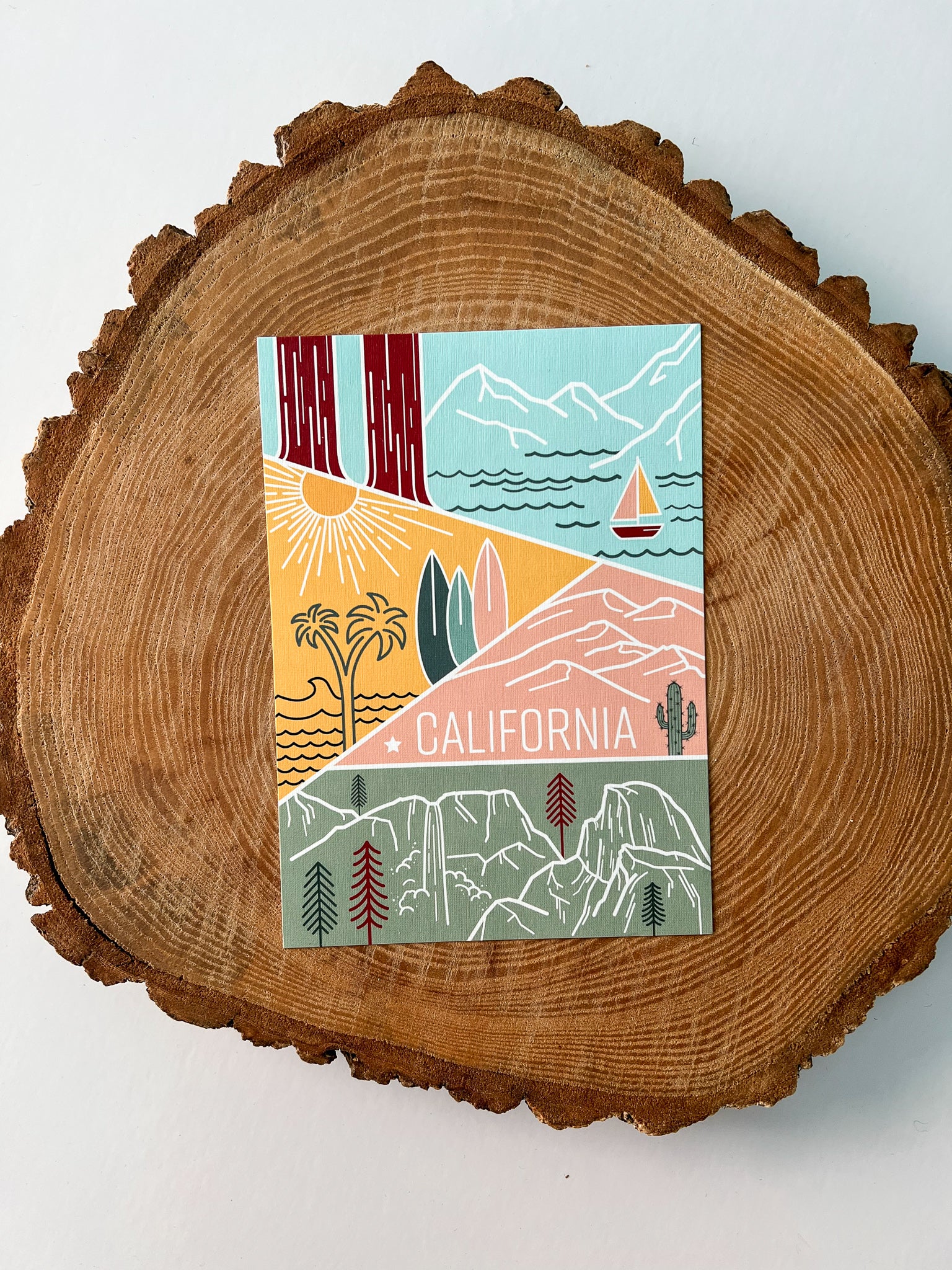 A colorful postcard featuring an illustration of California's landscape, including mountains, a beach, and iconic symbols like palm trees and a sailboat.
